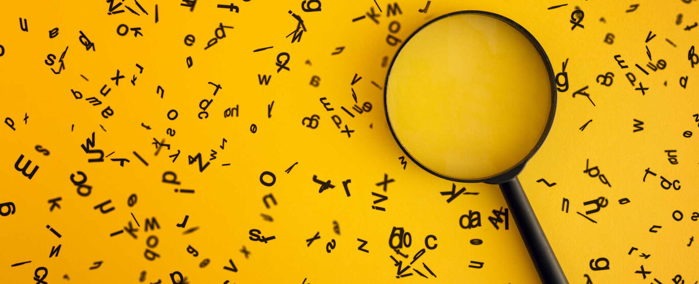 einzelne-schwarze-buchstaben-fliegen-vor-gelbem-hintergrund-auf-dem-eine-runde-lupe-liegt